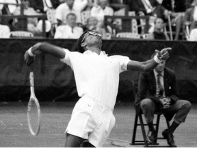 File-This Sept. 9, 1968, file photo shows Arthur Ashe in action during the inaugural U.S. Open Tennis Championship at Forest Hills in Queens, New York City. (AP Photo/ File)