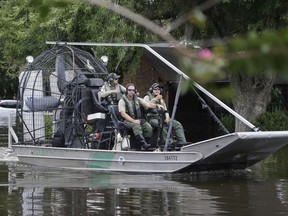 A U.S. Border Patrol air boat moves through neighborhood inundated by floodwaters from Tropical Storm Harvey in Houston, Texas, Wednesday, Aug. 30, 2017. John Morris, the Border Patrol's chief of staff in South Texas, said the agency had 35 boats in the city's flooded neighborhoods on Thursday, Aug. 31, 2017, and had rescued about 450 people since Monday. "The agents and the assets that are here in Houston as part of the recovery effort are absolutely 100 percent only here for rescue and safety," Morris said. "There is no enforcement activity being undertaken while we're doing this safety mission." (AP Photo/LM Otero)