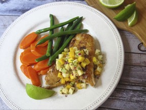 This Aug. 9. 2017 photo shows spicy sauteed fish with a pineapple mango salsa in New York. This dish is from a recipe by Sara Moulton. (Sara Moulton via AP)