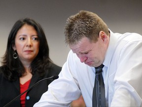 In this Jan. 9, 2009, photo, Innocence Project staff attorney Alba Morales, left, watches Steven Barnes fight back tears while speaking to Judge Michael L. Dwyer at Oneida County Court, in Utica, N.Y., about being officially exonerated of all the charges he was wrongfully convicted of in the 1985 slaying of 16-year-old Kimberly Simon. (Nicole L. Cvetnic/Observer-Dispatch via AP)