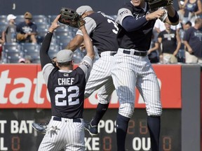 New York Yankees center fielder Jacoby Ellsbury (22), right fielder Aaron Judge, right, and left fielder Aaron Hicks celebrate after they defeated the Seattle Mariners in a baseball game Sunday, Aug. 27, 2017, at Yankee Stadium in New York. (AP Photo/Bill Kostroun)