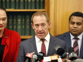 New Zealand Labour Party leader Andrew Little, center, announces he is quitting on Tuesday, Aug. 1, 2017, in Wellington, New Zealand. The Labour Party had been trying to overcome recent dismal polling seven weeks before the general election, and some believe new leader Jacinda Ardern will bring more charisma to the role and forge a stronger connection with younger voters. (AP Photo/Nick Perry)