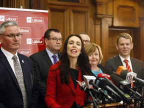 New Zealand's new Labour Party leader Jacinda Ardern, centre, and deputy leader Kelvin Davis, left, answer questions from reporters on Tuesday, Aug. 1, 2017, in Wellington, New Zealand. Within hours of becomign party leader, Ardern, 37, faced questions about whether she plans to have children.