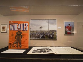 In this Tuesday, Aug. 1, 2017 photo,a Wheaties cereal box featuring NFL player Jim Thorpe sits in a display at the Canton Museum of Art in Canton, Ohio. A one-of-a-kind art exhibition devoted to football is making its last stop in Canton, the birthplace of the NFL. The exhibit opened Tuesday, days ahead of the Canton-based Pro Football Hall of Fame's enshrinement weekend.. (AP Photo/Dake Kang