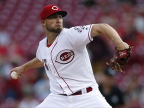 Cincinnati Reds starting pitcher Tim Adleman (46) throws against the San Diego Padres during the first inning of a baseball game, Monday, Aug. 7, 2017, in Cincinnati. (AP Photo/Gary Landers)