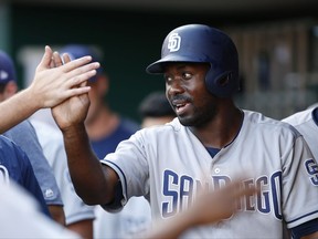 San Diego Padres left fielder Jose Pirela celebrates a score on a wild pitch by Cincinnati Reds starting pitcher Sal Romano during the first inning of a baseball game, Tuesday, Aug. 8, 2017, in Cincinnati. (AP Photo/Gary Landers)