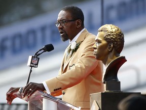 Former NFL player Kenny Easley speaks next a bust of himself during an induction ceremony at the Pro Football Hall of Fame Saturday, Aug. 5, 2017, in Canton, Ohio. (AP Photo/Ron Schwane)