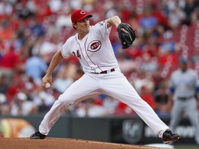 Cincinnati Reds starting pitcher Homer Bailey winds up during the first inning of a baseball game against the Chicago Cubs, Tuesday, Aug. 22, 2017, in Cincinnati. (AP Photo/John Minchillo)