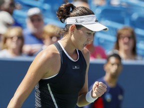 Garbine Muguruza, of Spain, reacts during a match against Svetlana Kuznetsova, of Russia, at the Western & Southern Open tennis tournament, Friday, Aug. 18, 2017, in Mason, Ohio. (AP Photo/John Minchillo)