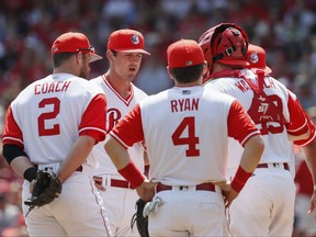 Cincinnati Reds starting pitcher Tyler Mahle, second from left, reacts as he meets on the mound with his teammates after giving up a two-run double by Pittsburgh Pirates' John Jaso in the fourth inning of a baseball game, Sunday, Aug. 27, 2017, in Cincinnati. (AP Photo/John Minchillo)