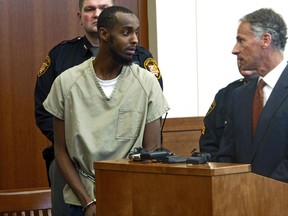 FILE – In this Feb. 25, 2015, file photo, Abdirahman Sheik Mohamud, front left, speaks with his attorney Sam Shamansky, right, during a hearing to set bond in Columbus, Ohio. Mohamud pleaded guilty to terrorism charges in 2015 and is asking for leniency at his scheduled sentencing Friday, Aug. 18, 2017, saying he abandoned his plan to kill military members in the U.S., Shamansky said in a Monday, Aug. 14, 2017, court filing. (AP Photo/Andrew Welsh-Huggins, File)