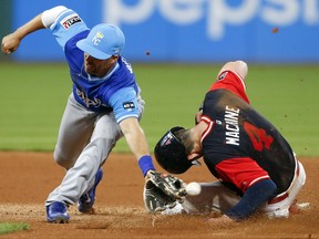 Cleveland Indians' Bradley Zimmer (4) steals second base as the ball gets away from Kansas City Royals' Whit Merrifield during the seventh inning in a baseball game, Saturday, Aug. 26, 2017, in Cleveland. (AP Photo/Ron Schwane)