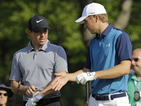 Jordan Spieth, right, and Rory McIlroy, from Northern Ireland, talk before teeing off on the 14th hole during the first round of the Bridgestone Invitational golf tournament at Firestone Country Club, Thursday, Aug. 3, 2017, in Akron, Ohio. (AP Photo/Tony Dejak)