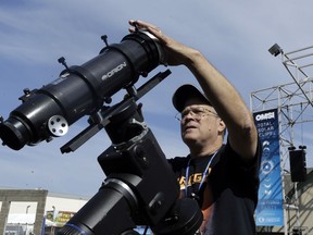 Ray Cooper, volunteer for the Oregon Museum of Science and Industry, preps his equipment to provide live video of the Aug. 21, 2017, solar eclipse at the state fairgrounds in Salem, Ore., Sunday, Aug. 20, 2017.(AP Photo/Don Ryan)