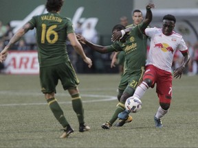 New York Red Bulls' Derrick Etienne Jr. (7) works for the ball against Portland Timbers' Diego Chara (21) during an MLS soccer match in Portland, Ore., Friday, Aug. 18, 2017. (Sean Meagher/The Oregonian via AP)