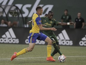 Portland Timbers' Darren Mattocks (11) works against Colorado Rapids' Kortne Ford during an MLS soccer match Wednesday, Aug. 23, 2017, in Portland, Ore. (Sean Meagher/The Oregonian via AP)