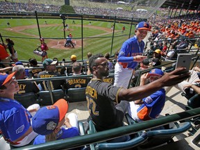 Grosse Pointe, Mich.'s Jordan Arseneau, standing, gets in a selfie taken by Pittsburgh Pirates' Andrew McCutchen (22) in the stands at Lamade Field during a baseball game between Fairfield, Conn., and Lufkin, Texas in United States pool play at the Little League World Series tournament in South Williamsport, Pa., Sunday, Aug. 20, 2017. The Pirates will be playing the St. Louis Cardinals in Bowman Stadium in Williamsport, Pa., on Sunday Night Baseball. (AP Photo/Gene J. Puskar)
