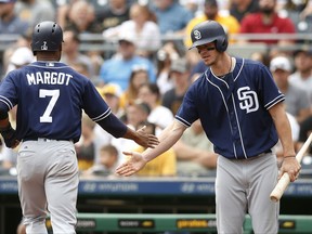 San Diego Padres' Wil Myers, right, congratulates teammate Manuel Margot after Margot scored in the first inning against the Pittsburgh Pirates during a baseball game in Pittsburgh, Sunday, Aug. 6, 2017. (AP Photo/Jared Wickerham)