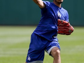 Los Angeles Dodgers pitcher Yu Darvish throws in the outfield at PNC Park before a scheduled baseball game against the Pittsburgh Pirates, Thursday, Aug. 24, 2017, in Pittsburgh. (AP Photo/Keith Srakocic)