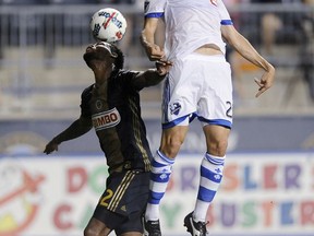 Montreal Impact's Matteo Mancosu and Philadelphia Union's Giliano Wijnaldum vie for the ball during the first half of an MLS soccer match Saturday, Aug. 12, 2017, in Chester, Pa. (AP Photo/Michael Perez)