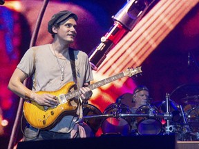FILE - In this June 12, 2016, file photo, John Mayer of Dead & Company performs at Bonnaroo Music and Arts Festival in Manchester, Tenn. Mayer paid tribute to Glen Campbell on Tuesday, Aug. 8, 2017, during his concert in Nashville, Tenn., hours after the country music legend died in the city. (Photo by Amy Harris/Invision/AP, File)