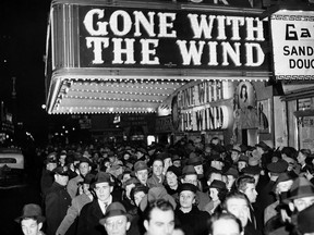In this Dec. 19, 1939 file photo, a crowd walks past the Astor Theater during the Broadway premiere of "Gone With the Wind" in New York. A Memphis, Tennessee, theatre has cancelled an annual screening of the classic 1939 film because of racially insensitive content.