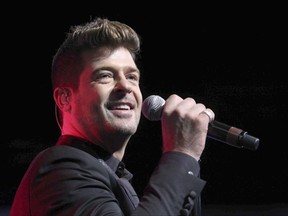 FILE - In this Aug. 7, 2015, file photo, Robin Thicke performs during the Steve Harvey Morning Show live broadcast at the Georgia World Congress Center in Atlanta. Thicke's girlfriend, April Love Geary, announced on Instagram Aug. 17, 2017, that she's expecting a baby with the singer.  (Photo by Robb D. Cohen/Invision/AP, File)