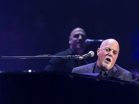 FILE - In this Nov. 21, 2016, file photo, Billy Joel performs at Madison Square Garden in New York. Joel performed at the arena on Aug. 21, 2017, with a yellow Star of David sewn to his sport coat. (Photo by Michael Zorn/Invision/AP, File)