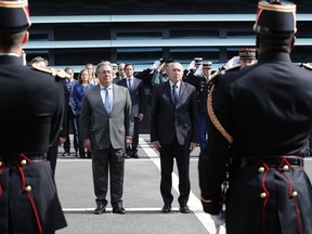 French Interior Minister Gerard Collomb, center right, and his Spanish counterpart Juan Ignacio Zoido Alvarez observe a minute of silence for the victims of the attacks in Spain, at the of the French Gendarmerie headquarters in Issy-les-Moulineaux, outside Paris, Wednesday Aug.23, 2017. Spanish police said they were investigating material found in searches in two northeastern towns, a day after a judge jailed two of the four surviving alleged cell members that carried out the attacks last week that killed 15 people. (AP Photo/Christophe Ena)