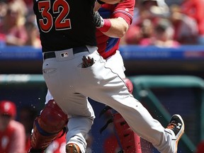 Miami Marlins' Derek Dietrich (32) is tagged out at home plate by Philadelphia Phillies catcher Cameron Rupp on a fielders choice hit by Vance Worley during the second inning of a baseball game Thursday, Aug. 24, 2017, in Philadelphia, Pa. (AP Photo/Rich Schultz)