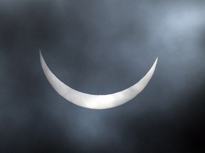 A partial solar eclipse is visible through a break in the cloud cover over Northern England on March 20, 2015.