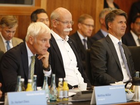 From right to left :  Harald Krueger, CEO of German car maker BMW, Dieter Zetsche, chairman of German car maker Daimler AG and head of Mercedes-Benz cars and Matthias Mueller, CEO of German car maker Volkswagen have taken seat to attend a so-called diesel summit on Wednesday, Aug. 2, 2017 in Berlin. German government officials and automakers meet to discuss the future of diesel vehicles, after a nearly two-year saga of scandal spread from Volkswagen to others in the sector. (Axel Schmidt/Pool Photo via AP)