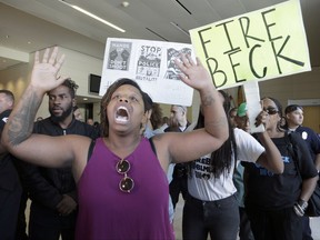 FILE--In this Oct. 3, 2016, file photo, protesters demand the firing of Los Angeles Police Chief Charlie Beck over a police-involved shooting of a black man over the weekend during a news conference at LAPD headquarters in Los Angeles. A civilian oversight board has found Tuesday, Aug. 15, 2017, that Los Angeles police officers acted within policy in the fatal shooting of an 18-year-old man that sparked several Black Lives Matter protests. (AP Photo/Nick Ut, file)