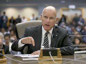 FILE- In this July 13, 2017, file photo, California Gov. Jerry Brown testifies during a hearing of the Senate Environmental Quality committee in Sacramento, Calif. Brown is traveling to Russia next week to discuss collaborating with Pacific nations on climate change at an economic forum hosted by the Russian government. (AP Photo/Rich Pedroncelli, File)