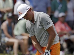 Rickie Fowler chips to the fifth green during the final round of the PGA Championship golf tournament at the Quail Hollow Club Sunday, Aug. 13, 2017, in Charlotte, N.C. (AP Photo/John Bazemore)
