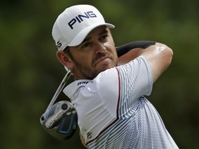 Louis Oosthuizen of South Africa, watches his tee shot on the third hole during the final round of the PGA Championship golf tournament at the Quail Hollow Club Sunday, Aug. 13, 2017, in Charlotte, N.C. (AP Photo/Chuck Burton)