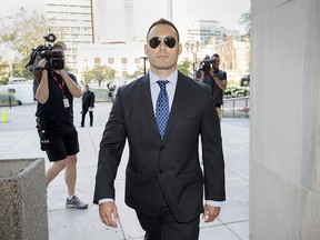 Toronto Police Services Constable Joshua Cabero arrives at Toronto's 361 University Avenue Courthouse to the fate of himself and two other constables charged with sex assault charges of a parking attendant, Wednesday August 9, 2017.