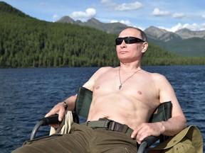 Russian President Vladimir Putin sunbathes during his vacation in the remote Tuva region in southern Siberia. The picture taken between August 1 and 3, 2017.