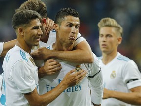 Real Madrid's Cristiano Ronaldo, center, celebrates after scoring during the Santiago Bernabeu Trophy soccer match between Real Madrid and Fiorentina at the Santiago Bernabeu stadium in Madrid, Spain, Wednesday, Aug. 23, 2017. (AP Photo/Paul White)