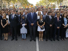 Spain's King Felipe, centre, Spain's Prime Minister Mariano Rajoy, 3rd left and Catalonia regional President Carles Puigdemont, 4th from right and other politicians take part in a demonstration condemning the attacks that killed 15 people last week in Barcelona, Spain, Saturday, Aug. 26, 2017. The Islamic State group has claimed responsibility for the attacks on Aug. 17-18 in Barcelona and Cambrils that also left more than 120 injured. Eight suspects are dead and four more under investigation, two of them in jail. (AP Photo/Francisco Seco)