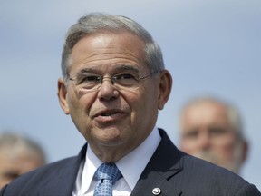 FILE - In this Thursday, Aug. 17, 2017 file photo, Sen. Bob Menendez, D-N.J., speaks during a news conference, in Union Beach, N.J. Menendez has asked the federal judge in his upcoming corruption trial to alter the trial schedule so he can be present for important Senate votes in Washington. The Democrat made the request Thursday, Aug. 24,  in a filing that mentions potential votes in September on raising the federal debt limit and approving a spending deal to avoid a government shutdown.  (AP Photo/Julio Cortez, File)