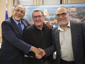 Boufeldja Benabdallah, from left to right, interim coordinator at the Centre Islamique de Quebec, Quebec City mayor Régis Labeaume and Mohamed Labidi shake hands after they announced the establishment of a Muslim cemetery, at City Hall in Quebec City on Friday, August 4, 2017.