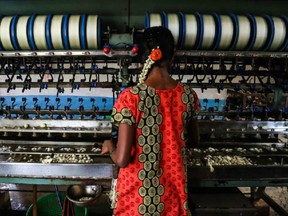 An underage laborer in the informal economy works in a silk factory in Sidlaghatta, India.