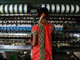 An underage laborer in the informal economy works in a silk factory in Sidlaghatta, India.