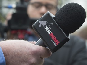 MISSISSAUGA, ONTARIO: April 25, 2017 - David ìThe Menzoidî Menzies, Rebelís Media 'Mission Specialist', holds a Rebel Media microphone at a rally against religious accommodation in schools in front to the Peel District School Board in Mississauga, Ontario, April 25, 2017.   (Tyler Anderson /  National Post)  (For National story by Richard Warnica)