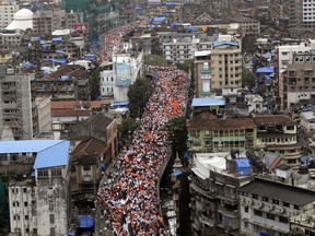 Members of Maratha Kranti Morcha, or Maratha Revolutionary Front take out a silent march in Mumbai, India, Wednesday, Aug. 9, 2017. Tens of thousands of people waving saffron flags are marching through Mumbai demanding quotas in government jobs and education for the Maratha community in western India. (AP Photo/Rajanish Kakade)