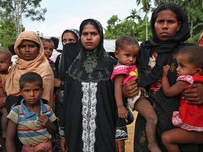 Members of Myanmar's Muslim Rohingya ethnic minority wait to enter the Kutupalong makeshift refugee camp in Cox's Bazar, Bangladesh, Monday, Aug. 28, 2017. Violence in Myanmar's western Rakhine state has driven thousands of ethnic Rohingya Muslims fleeing toward Bangladesh for safety, along with a smaller exodus of ethnic Rakhine Buddhists. (AP Photo/Mushfiqul Alam)