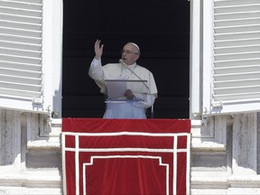 Pope Francis delivers his blessing from his studio's window overlooking St. Peter's Square, at the Vatican, Sunday, Aug. 13, 2017. (AP Photo/Gregorio Borgia)