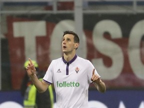 FILE - In this Feb. 19, 2017 file photo Fiorentina's Nikola Kalinic celebrates after scoring during a Serie A soccer match between AC Milan and Fiorentina, at the San Siro stadium in Milan, Italy. In a brief statement on Tuesday, Aug. 22, 2017 AC Milan said it is "delighted to announce the signing of Nikola Kalinic from Fiorentina ACF on a loan deal with obligation to buy." (AP Photo/Antonio Calanni, file)
