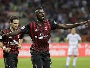 FILE - In this Sept. 20, 2016 file photo, AC Milan's Mbaye Niang celebrates after scoring during the Serie A soccer match between AC Milan and Lazio at the San Siro stadium in Milan, Italy. After signing 11 new players in the offseason, AC Milan needed to offload those surplus to requirements and French striker M'Baye Niang has gone on loan to Torino. (AP Photo/Antonio Calanni)